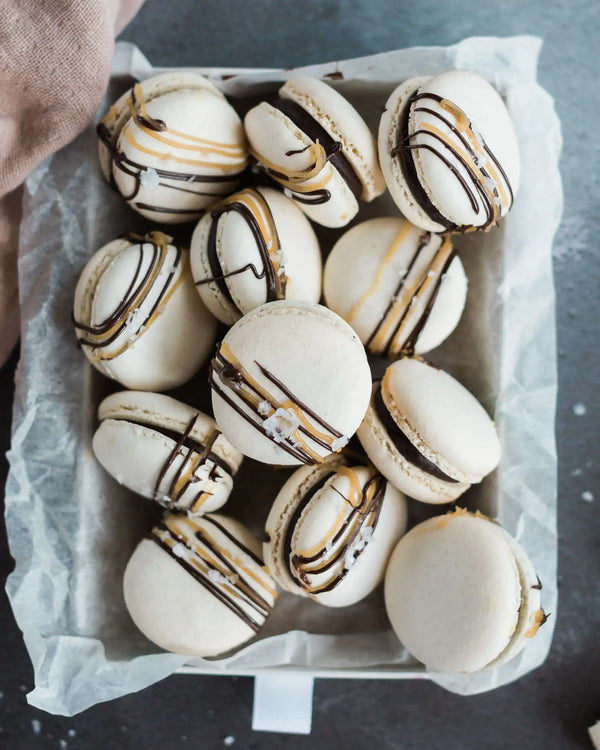 Honeywell Bakes Salted Caramel Macaron Kit - Box of macarons with chocolate drizzle on a grey surface