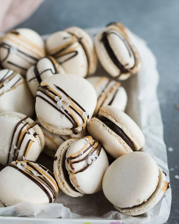 Honeywell Bakes Salted Caramel Macaron Kit - Box of macarons with chocolate drizzle on a grey surface