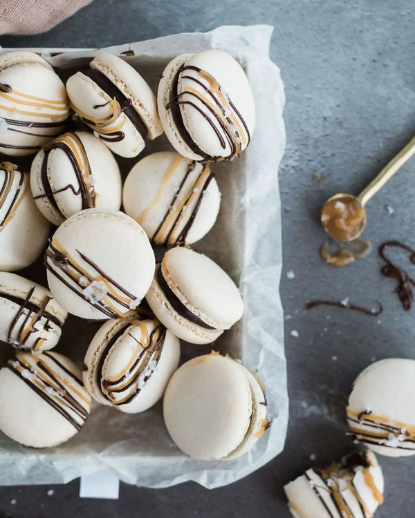 Honeywell Bakes Salted Caramel Macaron Kit - Box of macarons with chocolate drizzle on a grey surface