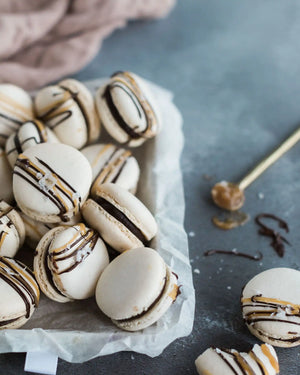 Honeywell Bakes Salted Caramel Macaron Kit - Box of macarons with chocolate drizzle on a grey surface