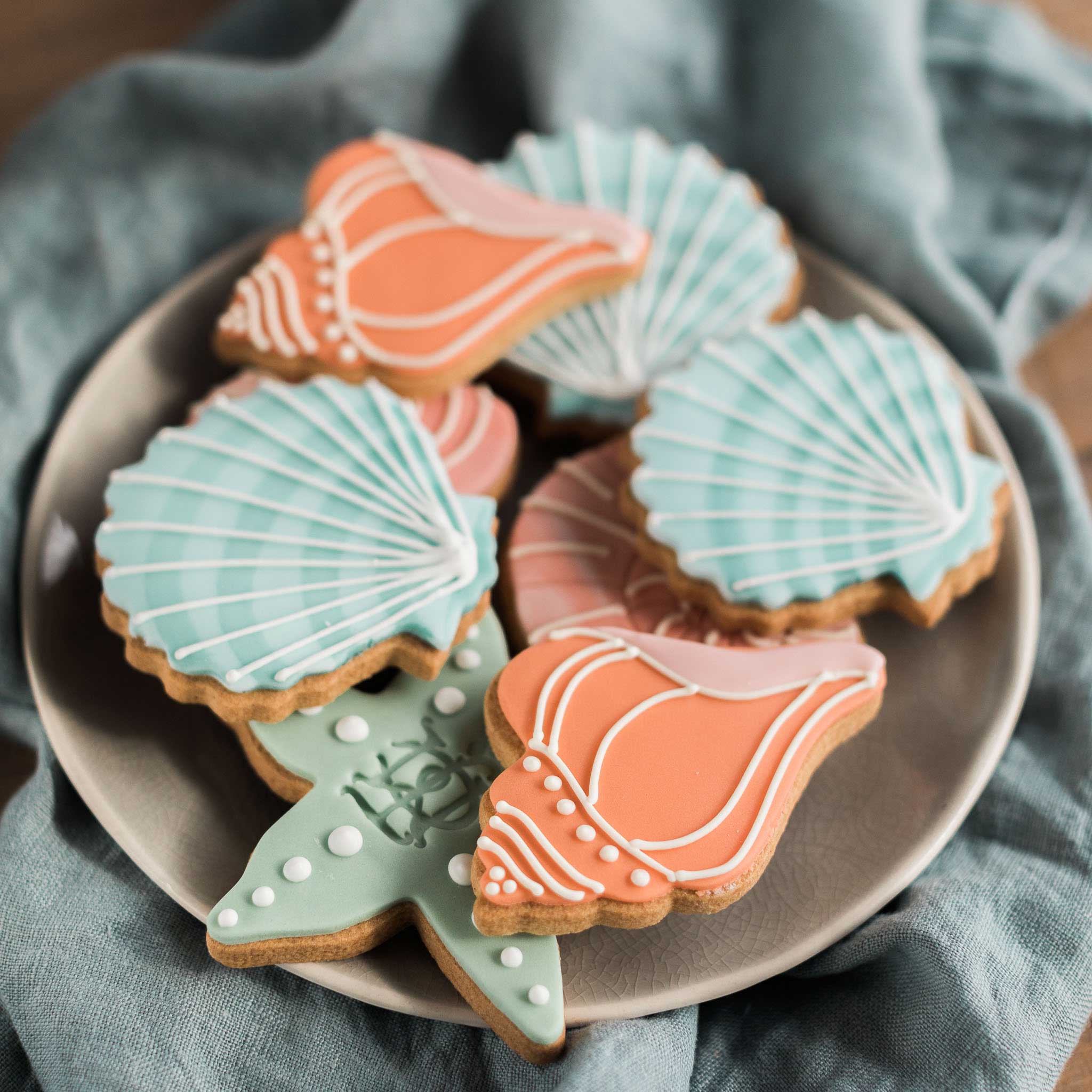 Hand iced seashell biscuits in brand colours for Jessica McCormack