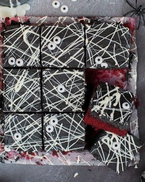 Honeywell Bakes Spooky Traybake Baking Kit - Halloween-themed brownies with spider webs and eyeballs on a dark background