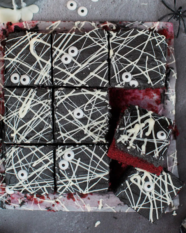Honeywell Bakes Spooky Traybake Baking Kit - Halloween-themed brownies with spider webs and eyeballs on a dark background