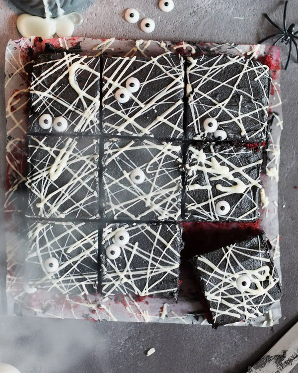 Honeywell Bakes Spooky Traybake Baking Kit - Chocolate cake with white spider web decoration on a gray surface