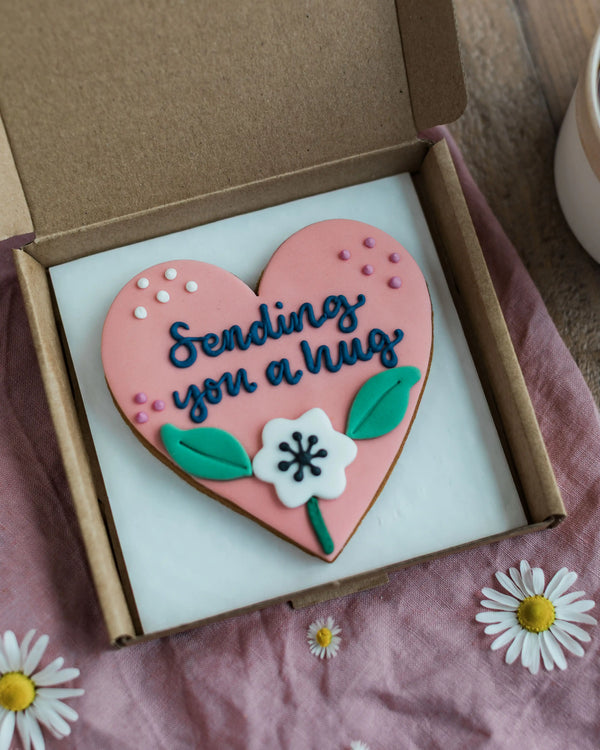 Honeywell Bakes Sweetheart Biscuit – Fully Iced Personalised Heart - Heart-shaped cookie with ’Sending You a Hug’ in a gift box with daisies.