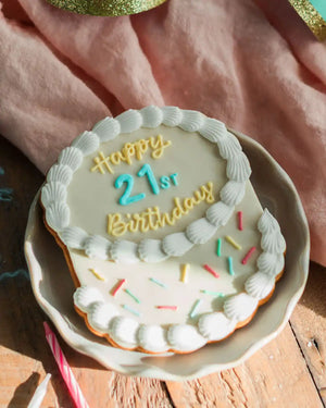 Honeywell Bakes The Big Birthday Biscuit - Classic WhiteCookie with 'Happy 21st Birthday' text on a wooden surface