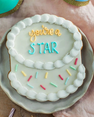 Honeywell Bakes The Big Birthday Biscuit - Cookie with 'you're a star' text and colourful sprinkles on a plate.