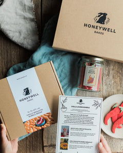 The Chilli Lovers Bundle by Honeywell Bakes, featuring a Chilli Biscuit Roulette jar of surprise-spice shortbread biscuits and a Chilli Roulette Bubble Bread baking kit with three different heat levels, presented in sustainable kraft gift packaging.