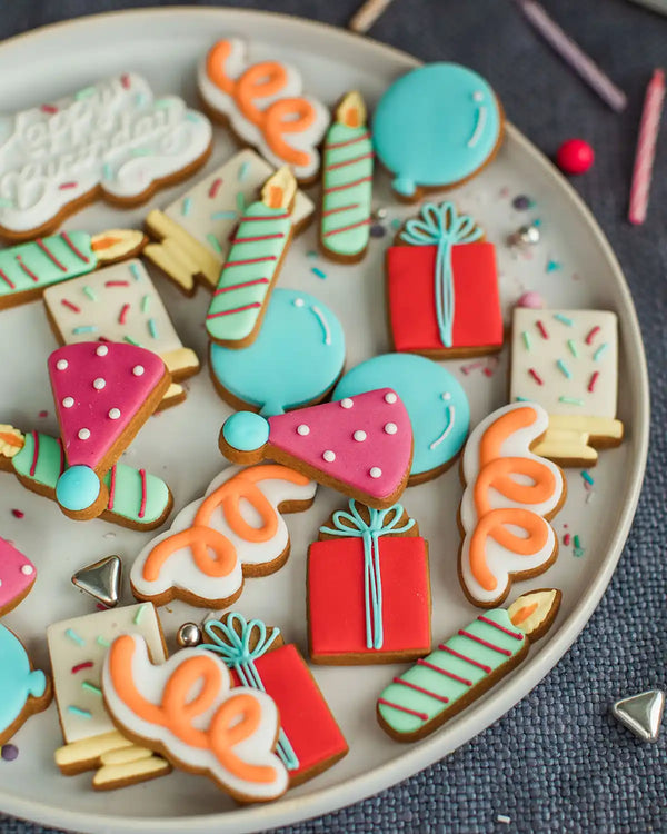 Honeywell Bakes The Happy Birthday Biscuit Jar - Colourful decorated cookies shaped like birthday items on a plate.