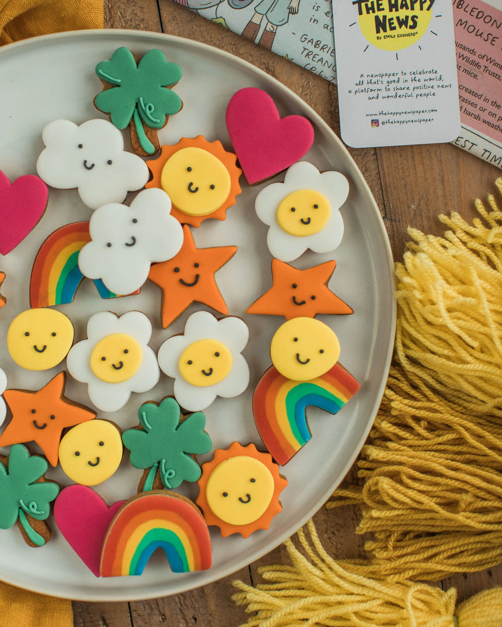 Honeywell Bakes The Happy News Biscuit Jar - Jar of colourful cookies with a 'Happy Biscuits' label on a wooden surface