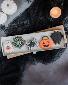 Honeywell Bakes Trick Or Treat Biscuit Gift - Box of Halloween-themed cookies with decorative elements on a dark background.
