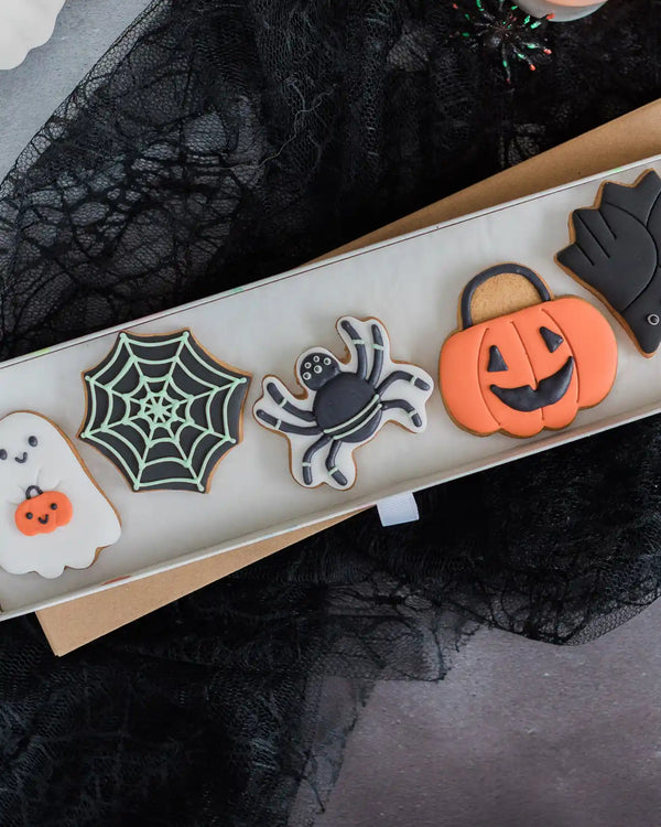 Honeywell Bakes Trick Or Treat Biscuit Gift - Halloween-themed cookies on a tray with spider web, ghost, and pumpkin designs.