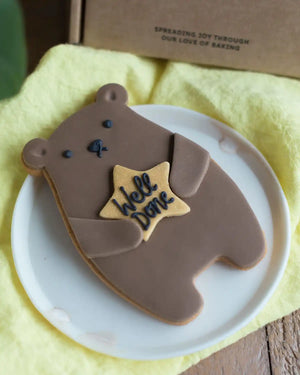 Honeywell Bakes Well Done Biscuit Bear - Cookie shaped like a bear with a 'Well Done' star on a white plate