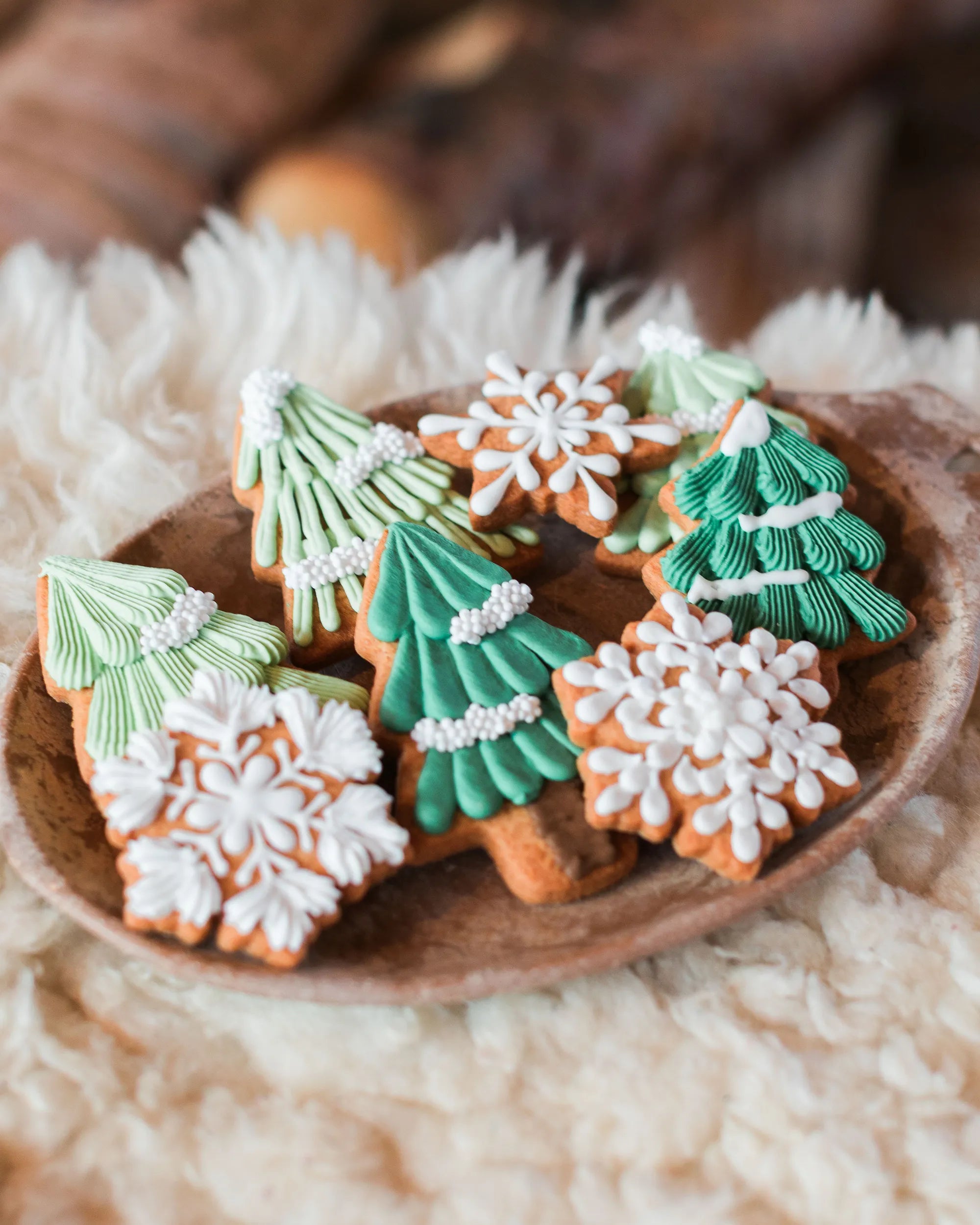Honeywell Bakes hand iced winter biscuits for events, Decorated Christmas tree and snowflake gingerbread cookies on a party platter