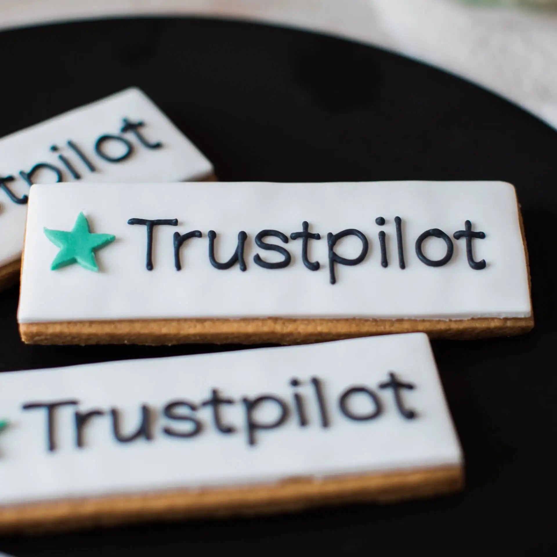 Hand iced custom Trustpilot logo branded biscuits